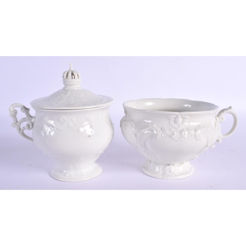 33 - A PAIR OF KPM BERLIN CUPS AND SAUCERS moulded with foliage. 15 cm x 15 cm. (2)