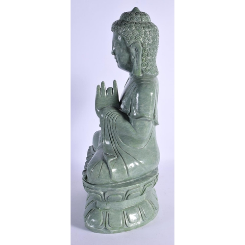 344 - A LARGE MID 20TH CENTURY CHINESE CARVED JADE TYPE FIGURE OF A BUDDHA elegantly modelled upon a lotus... 