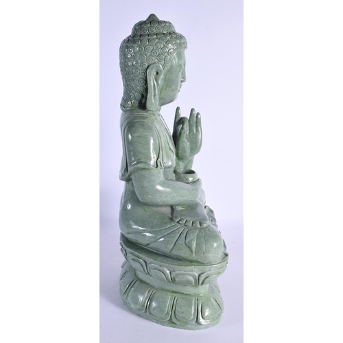 344 - A LARGE MID 20TH CENTURY CHINESE CARVED JADE TYPE FIGURE OF A BUDDHA elegantly modelled upon a lotus... 