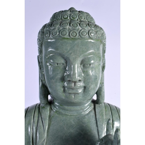 344 - A LARGE MID 20TH CENTURY CHINESE CARVED JADE TYPE FIGURE OF A BUDDHA elegantly modelled upon a lotus... 