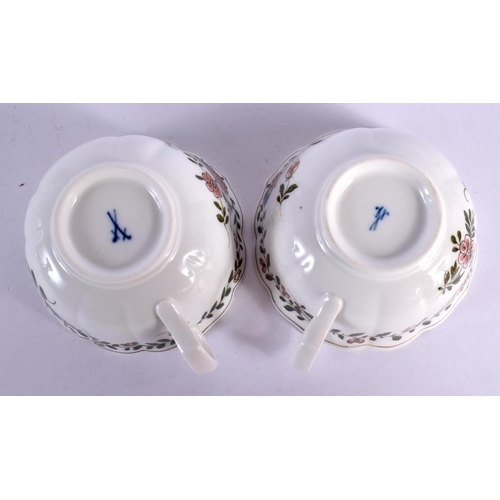 35 - A PAIR OF MEISSEN CUPS AND SAUCERS painted with flowers. 12 cm wide. (4)