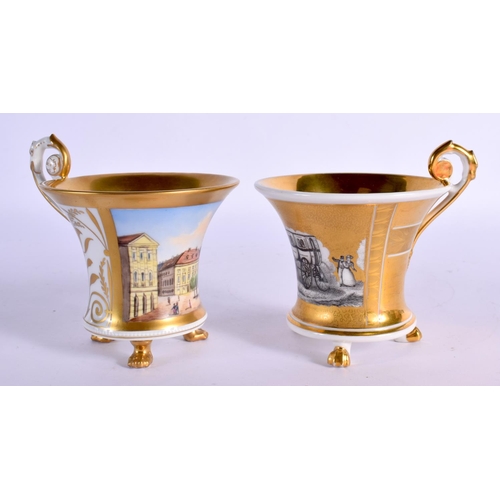 36 - A FINE PAIR OF KPM BERLIN CUPS AND SAUCERS highlighted in gilt and painted with landscapes. 10 cm di... 