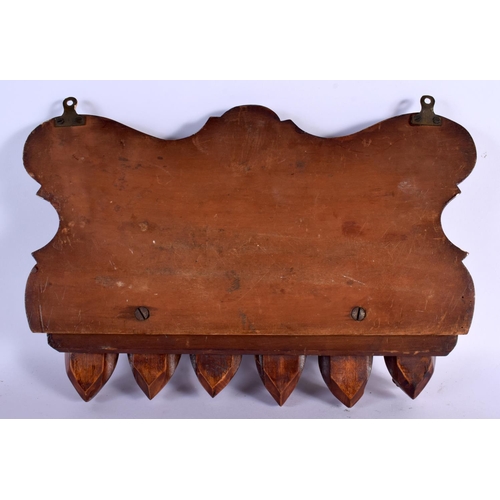 387 - A RARE EARLY 20TH CENTURY EUROPEAN CARVED WOOD WALL MOUNTED PIPE RACK formed as mischievous mask hea... 