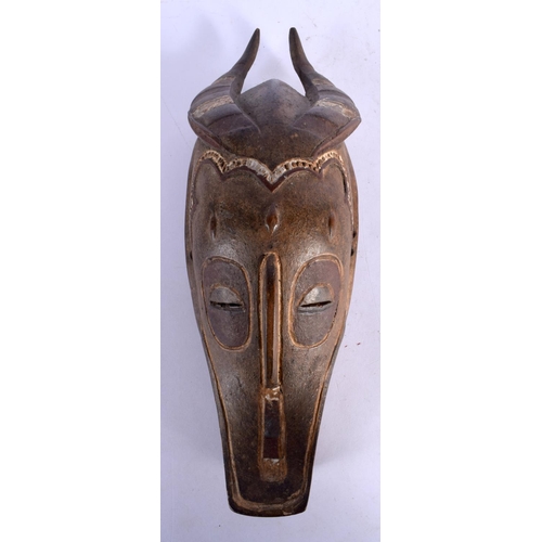 398 - A VINTAGE AFRICAN TRIBAL CARVED WOOD MASK. 34 cm x 10 cm.