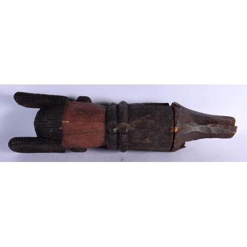 423 - AN AFRICAN TRIBAL CARVED WOOD FIGURAL POST. 50 cm long.