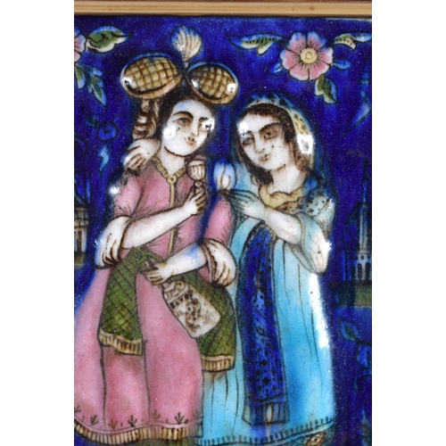 433 - AN 19TH CENTURY IRANIAN ISFAHAN QAJAR MOULDED POLYCHROME TILE depicting lovers within a landscape. 3... 