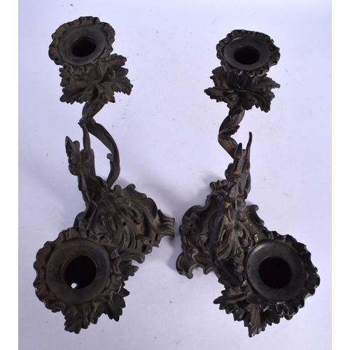 453 - A PAIR OF 19TH CENTURY BRONZE TWIN HANDLED CANDLESTICKS of scrolling form. 24 cm x 22 cm.