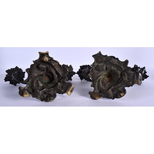 453 - A PAIR OF 19TH CENTURY BRONZE TWIN HANDLED CANDLESTICKS of scrolling form. 24 cm x 22 cm.