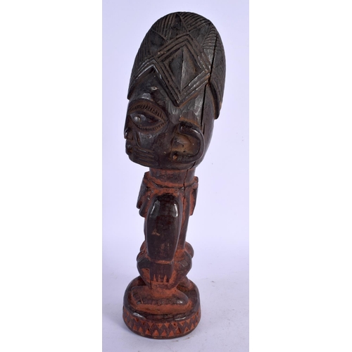 477 - AN AFRICAN TRIBAL CARVED WOOD FIGURE. 27 cm high.