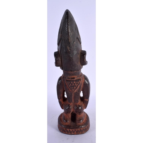 477 - AN AFRICAN TRIBAL CARVED WOOD FIGURE. 27 cm high.