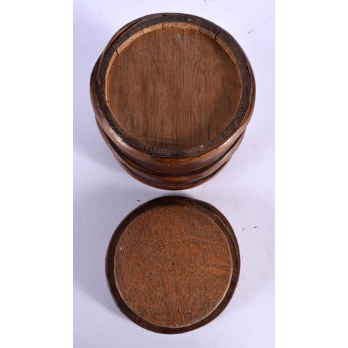 486 - A TREEN CARVED WOOD SLIDING BARREL BOX AND COVER. 11 cm x 9 cm.