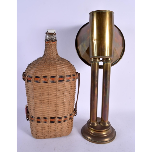 549 - AN UNUSUAL BRASS LAMP and a wicker bottle. Largest 41 cm high. (2)