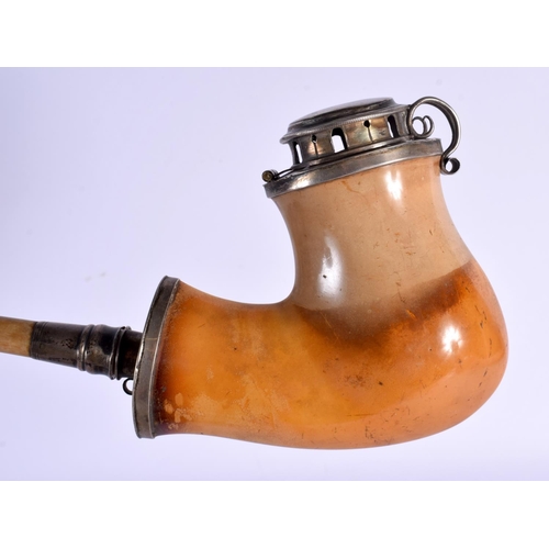 563 - AN ANTIQUE PIPE and a book. Largest 50 cm wide. (2)