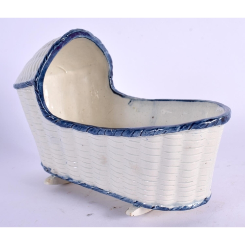 57 - A LATE 18TH/19TH CENTURY PEARLWARE MODEL OF A BABIES CRIB with blue border. 14 cm x 10 cm.