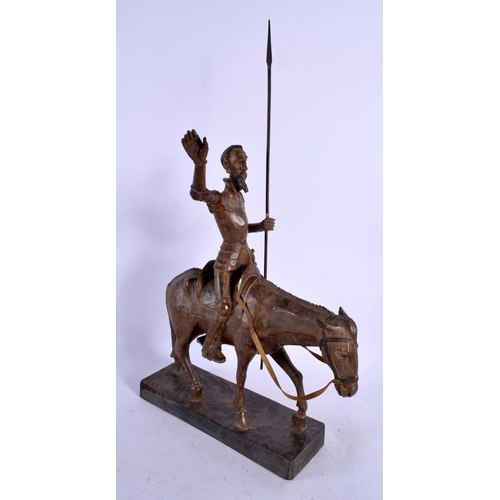 608 - A VINTAGE CARVED WOOD FIGURE OF A MALE UPON A HORSE. 45 cm high.