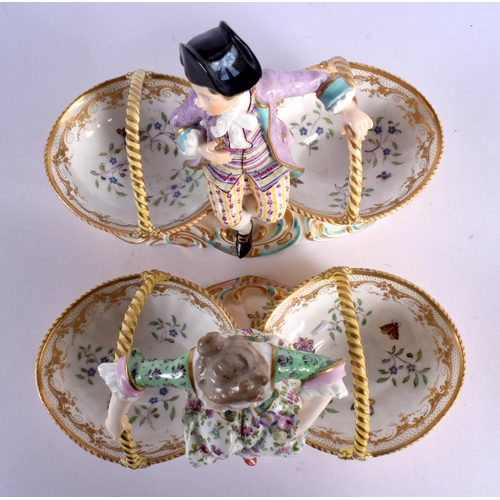 61 - A PAIR OF 19TH CENTURY EUROPEAN TWIN HANDLED PORCELAIN TABLE SALTS modelled as figures upon baskets.... 