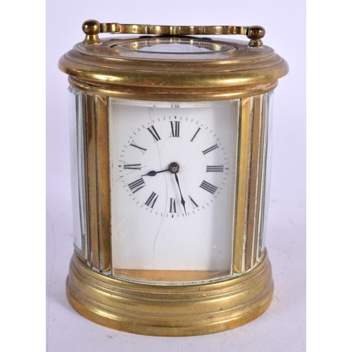 611 - A CASED MINIATURE BRASS CARRIAGE CLOCK. 8 cm high inc handle.