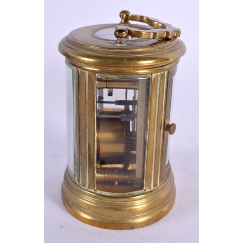 611 - A CASED MINIATURE BRASS CARRIAGE CLOCK. 8 cm high inc handle.