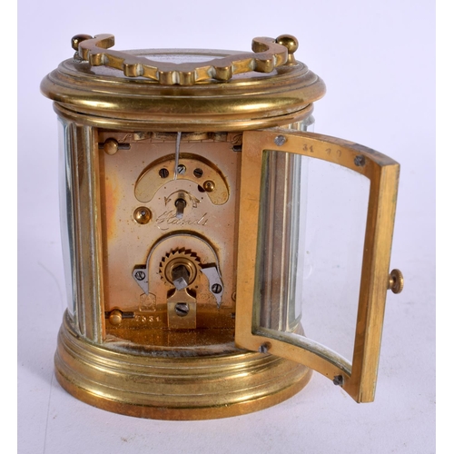 611 - A CASED MINIATURE BRASS CARRIAGE CLOCK. 8 cm high inc handle.