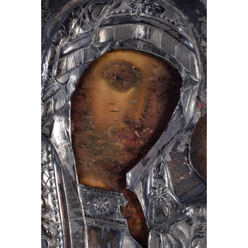 613 - AN ANTIQUE RUSSIAN SILVER MOUNTED WOOD ICON. 27 cm x 21 cm.