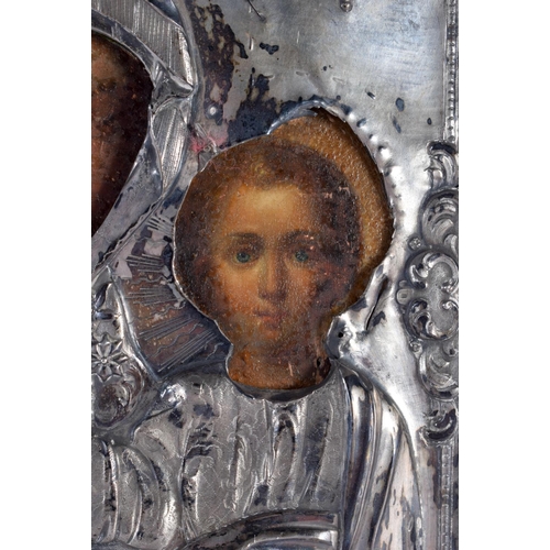 613 - AN ANTIQUE RUSSIAN SILVER MOUNTED WOOD ICON. 27 cm x 21 cm.