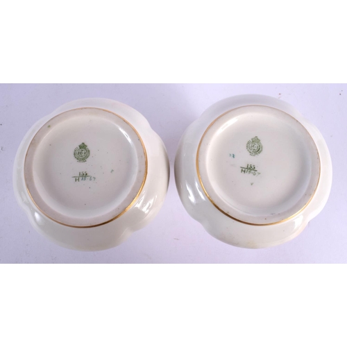 67 - A PAIR OF ROYAL WORCESTER TWIN HANDLED PORCELAIN VASES painted with roses. 9 cm x 6 cm.