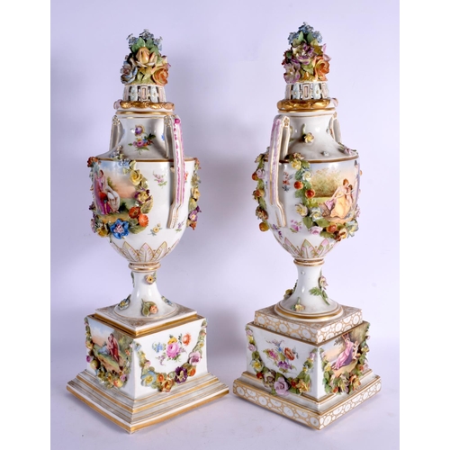 70 - A PAIR OF LATE 19TH CENTURY GERMAN DRESDEN PORCELAIN VASES AND COVERS painted with landscapes. 47 cm... 