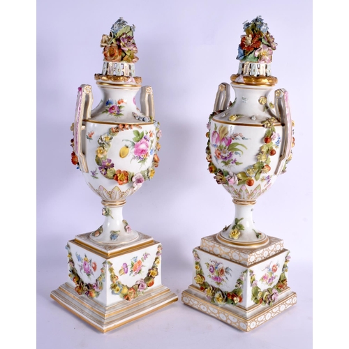 70 - A PAIR OF LATE 19TH CENTURY GERMAN DRESDEN PORCELAIN VASES AND COVERS painted with landscapes. 47 cm... 