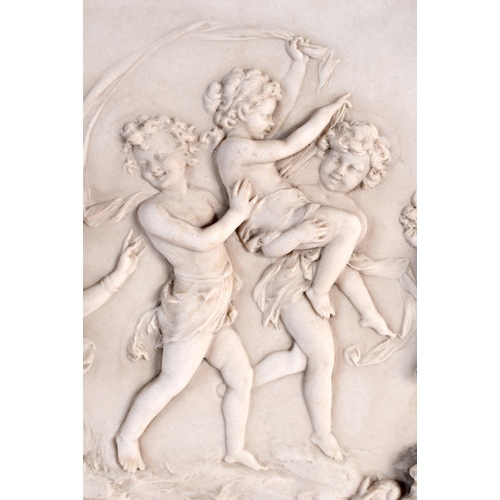 71 - A CLASSICAL PLAQUE decorated with putti. 34 cm x 20 cm.