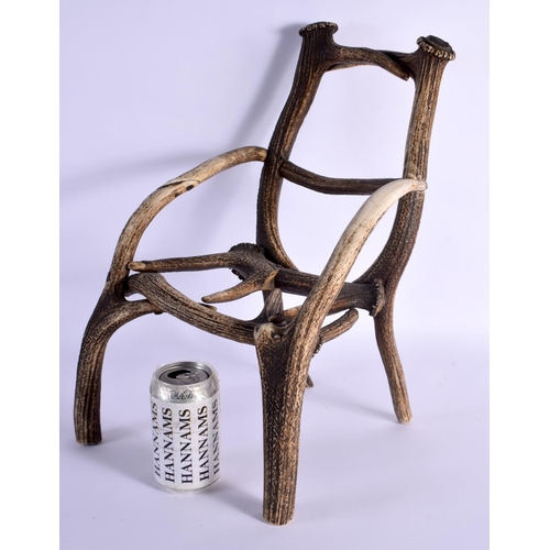 740 - A RARE CHILDS TAXIDERMY CARVED ANTLER CHAIR. 45 cm x 23 cm.