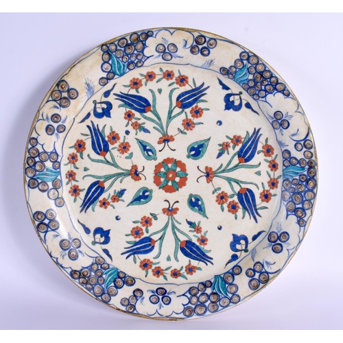 747 - A LARGE OTTOMAN TURKISH IZNIK FAIENCE PLATE painted with flowers. 32 cm diameter.