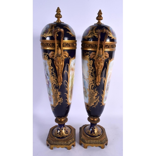 81 - A LARGE PAIR OF 19TH CENTURY FRENCH SEVRES PORCELAIN VASES AND COVERS painted with figures and lands... 