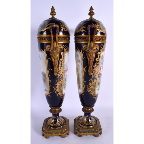 81 - A LARGE PAIR OF 19TH CENTURY FRENCH SEVRES PORCELAIN VASES AND COVERS painted with figures and lands... 