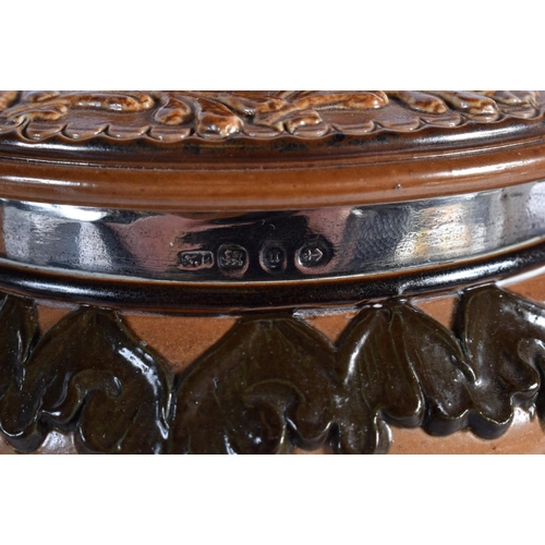 85 - A VICTORIAN SILVER MOUNTED DOULTON LAMBETH  BISCUIT BARREL AND COVER together with a candlestick and... 