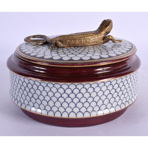 86 - A CONTEMPORARY BRONZE AND POTTERY BOX AND COVER. 12 cm diameter.