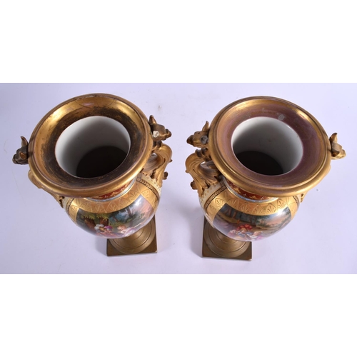 99 - A PAIR OF 19TH CENTURY TWIN HANDLED VIENNA PORCELAIN VASES with bronze mounts. 28 cm x 12 cm.