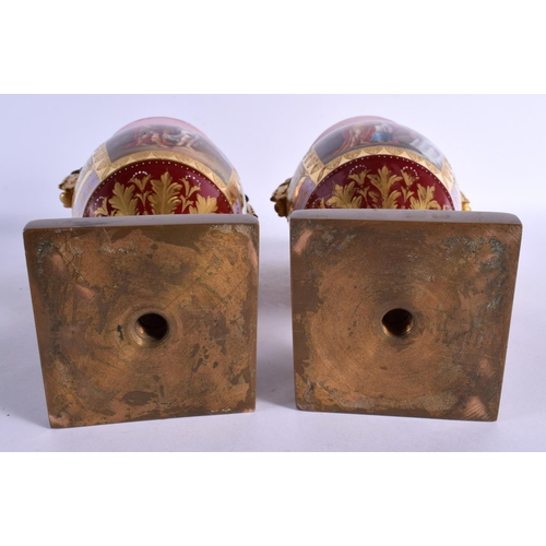 99 - A PAIR OF 19TH CENTURY TWIN HANDLED VIENNA PORCELAIN VASES with bronze mounts. 28 cm x 12 cm.