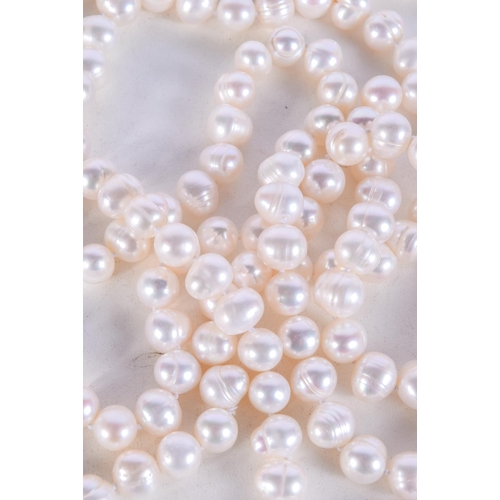 1004 - A STRING OF PEARLESCENT BEADS.  Length 128cm, bead size 9.2mm, weight 157g