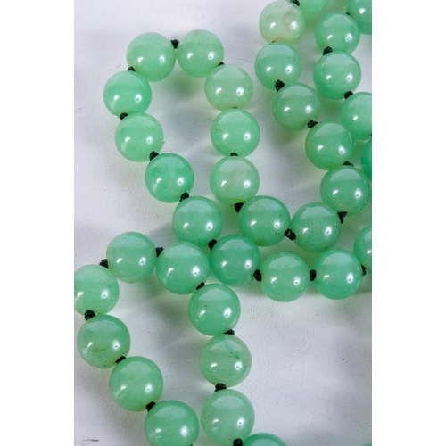 1009 - A STRING OF JADE TYPE BEADS.  Length 84cm, bead size 11.6mm, weight 159g