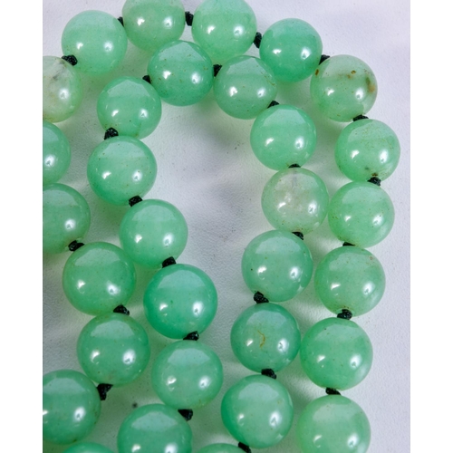 1009 - A STRING OF JADE TYPE BEADS.  Length 84cm, bead size 11.6mm, weight 159g