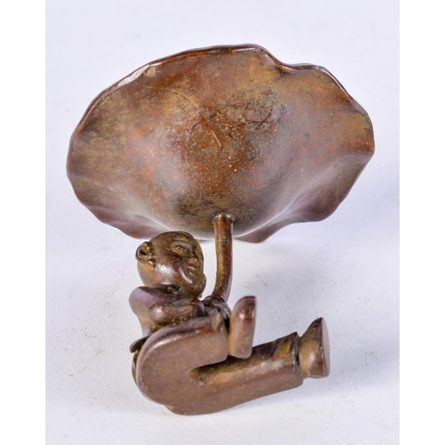 1010 - A JAPANESE BRONZ OF A SEATED BOY HOLDING ALOFT A LILLY PAD.  6.1cm x 6.3cm, weight 126.7g