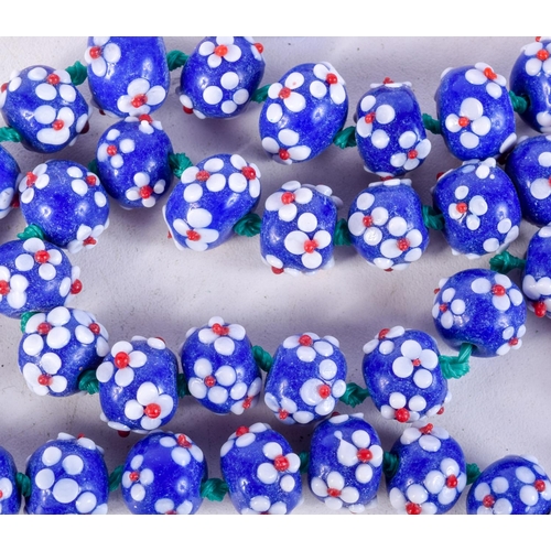 1021 - 2 STRINGS OF ITALIAN GLASS BEADS.  Both 76cm long, total weight 374g