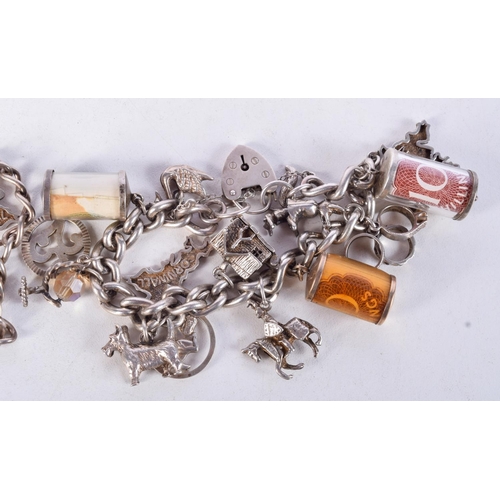 1071 - TWO SILVER CHARM BRACELETS WITH ASSORTED CHARMS.  Total weight 140g