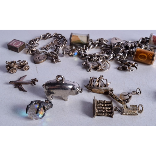 1071 - TWO SILVER CHARM BRACELETS WITH ASSORTED CHARMS.  Total weight 140g