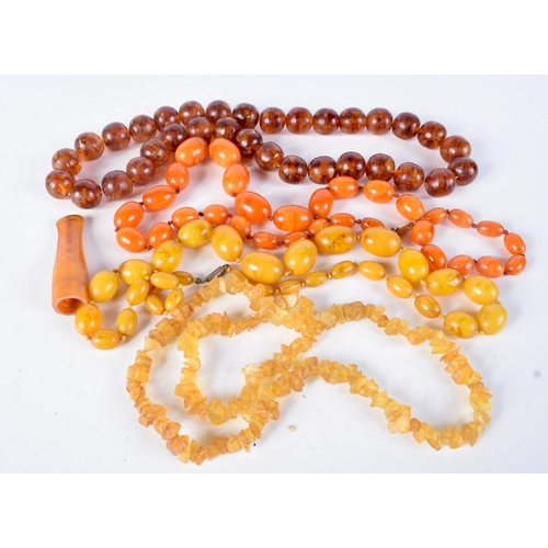 791 - FOUR  AMBER TYPE AND BAKELITE NECKLACES TOGETHER WITH A CIGAR HOLDER.  Longest 66cm, total weight 36... 