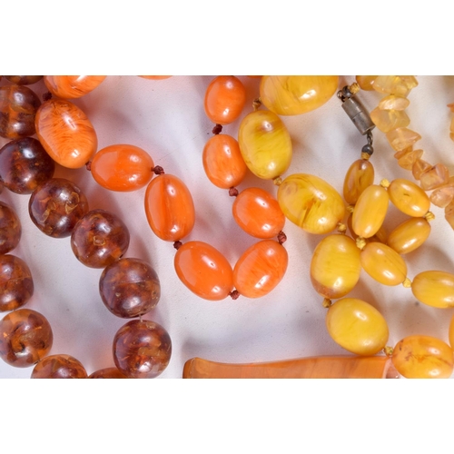 791 - FOUR  AMBER TYPE AND BAKELITE NECKLACES TOGETHER WITH A CIGAR HOLDER.  Longest 66cm, total weight 36... 