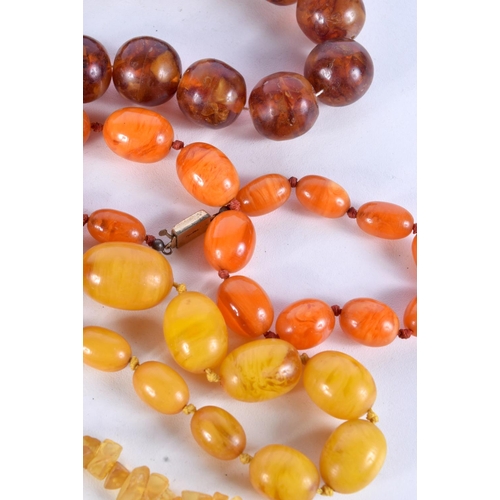 791 - FOUR  AMBER TYPE AND BAKELITE NECKLACES TOGETHER WITH A CIGAR HOLDER.  Longest 66cm, total weight 36... 