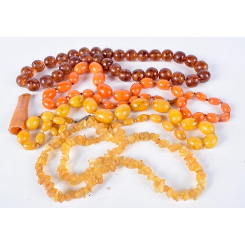 791 - FOUR  AMBER TYPE AND BAKELITE NECKLACES TOGETHER WITH A CIGAR HOLDER.  Longest 66cm, total weight 36... 