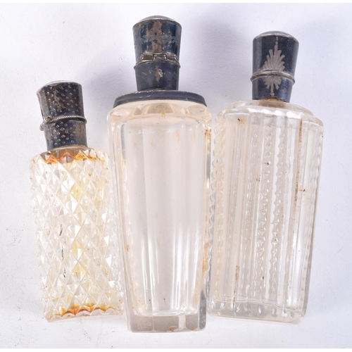 832 - THREE SILVER TOPPED SCENT BOTTLES.  Largest 9.4cm high (3)