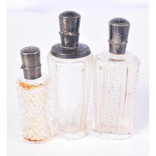 832 - THREE SILVER TOPPED SCENT BOTTLES.  Largest 9.4cm high (3)